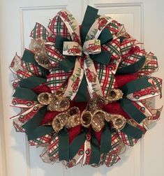 a christmas wreath on the front door decorated with bells and ribbon, featuring santa's sleigh