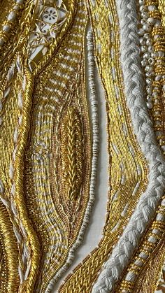 gold and silver beaded fabric with white thread