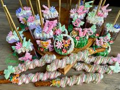 a table topped with lots of different types of cookies and candies covered in icing