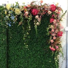 an artificial wall with flowers on it