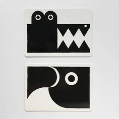 two black and white stickers on a white surface with an image of a monster in the middle