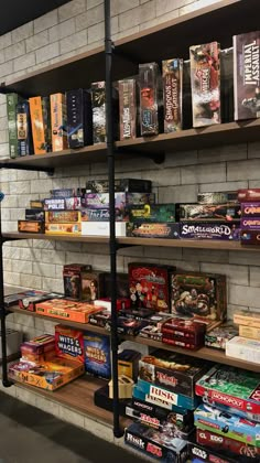 the shelves are filled with various games and books for sale in a game store or gaming room