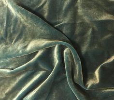 a close up view of a green velvet fabric