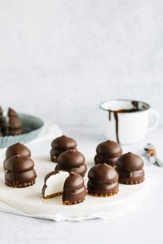 chocolate covered desserts sitting on top of a white plate