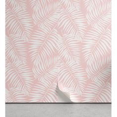 pink and white wallpaper with palm leaves on the side, in front of a concrete floor