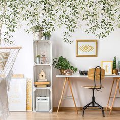 a room with two desks and some plants on the wall next to each other