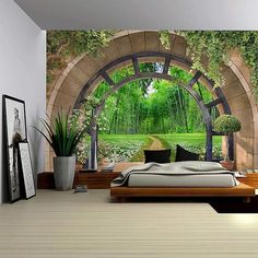 a bedroom with an archway leading to a lush green forest