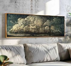 a painting hanging on the wall above a couch