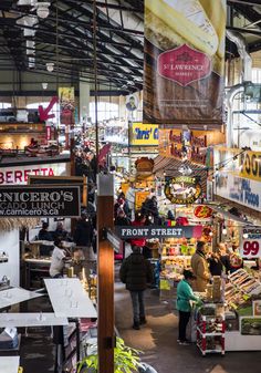 an indoor market with people shopping in it