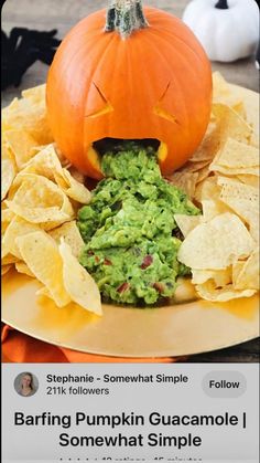 a plate with chips, guacamole and a jack - o'- lantern