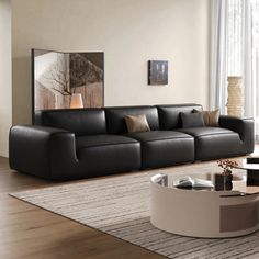 a modern living room with black leather furniture