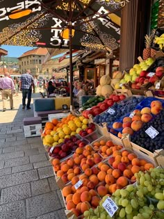 an open air market with lots of fruit on display