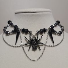 Handmade, black spider beaded choker necklace with lobster clasp. All necklaces come on a bookmark for reduced waste! A small microfiber cloth will also be included for polishing. Spring Goth Necklace, Summer Goth Necklace, Dark Jewelry Bead, Gothic Black Necklace With Lobster Clasp, Black Gothic Necklace With Lobster Clasp, Black Themed Necklace For Halloween, Adjustable Black Themed Necklace, Themed Black Necklace For Halloween, Halloween Themed Black Necklace