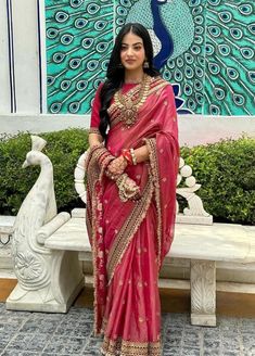 a woman in a red sari posing for the camera