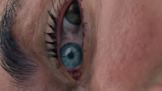 an extreme close up shot of someone's eye with the iris partially open,