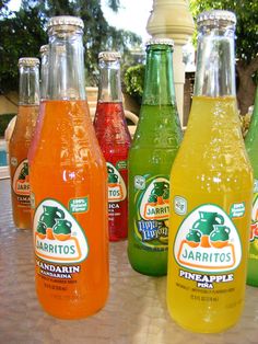 six bottles of juice sitting on top of a table