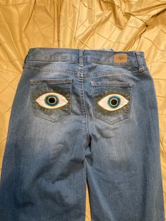 an eyeballed pair of jeans is shown on a bed