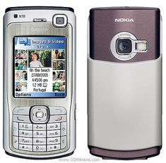 an old nokia cell phone with earphones on it's back and front sides