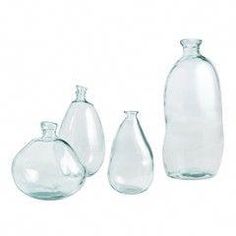 three clear glass vases and one empty bottle