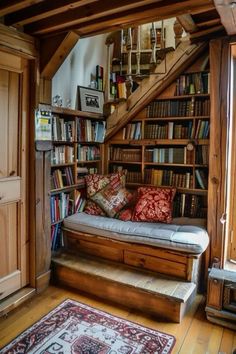 a living room filled with furniture and bookshelves next to a stair case full of books