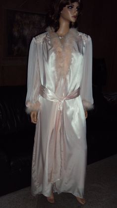 This is a very RARE Vintage 90's JONQUIL By DIANE SAMANDI Light Pink Wet Looking Satin, Laced, Beading, Pleated Nylon chiffon With Maribo Feathers Long / Tall Nightgown & Robe Set that is tagged a size Large in both pieces of the set but by their style & measurements will fit both some size Medium's & some size Large's thus my listing. SEE MEASUREMENTS FOR PROPER FITTING. The sets pieces are in very good vintage condition ! The NIGHTGOWN comes with a netted , laced , beading & sequends  cowl neck & front ( see pics ) , a low sensual back ( see pics ) that also has a laced lower pleated chiffon nylon insert ( see more pics )  , non adjustable shoulder straps & a tapered full hem. BUST  34 - 38 more fully stretched with at the size 38 bust measurement A or B Bust cup sizing, WAIST  to 38, HI Full-length Gown For Wedding Night, Vintage Satin Sleepwear For Wedding, Vintage Satin Wedding Sleepwear, Silk Fitted Robe For Wedding Night, Sheer Long Sleeve Wedding Nightgown, Fitted Long Sleeve Wedding Nightgown, Pink Silk Sleepwear For Evening, Long Sleeve Silk Wedding Sleepwear, Nightgown Robe