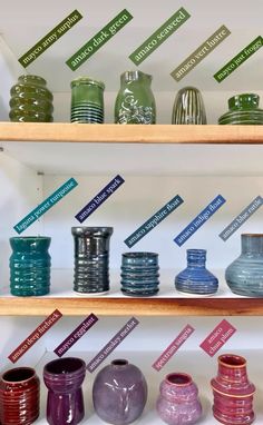 there are many different vases on the shelves