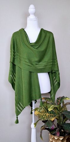 This green colour merino wool cape is very elegant and is suited to complement different outfits, it is also suitable for weddings or other formal events in your life. It's the simplest way to add some colour and freshness to your wardrobe and stylize your everyday garments. A great gift for a loved one.    Knitted 100% merino wool ponchos. The poncho is available in one size. ❤️ Several wearing variants: as poncho, scarf, headgear, beach tunic, scarf, cape, vest and etc. ❤️ Handmade with love for you Gift wrapping available.  Hand washed in lukewarm water with delicate detergent, better flat to dry.  Please note that the colours might be a little different on your computer screen. Shawl Poncho For Layering, One Size Shawl Poncho For Layering, Elegant Oversized Cape Shawl, Elegant One-size Cape Poncho, Elegant One Size Cape Poncho, Oversized Poncho Shawl With Scarf Detail, Bohemian Shawl For Layering, Elegant Wool Poncho Shawl, Elegant Wool Shawl Poncho