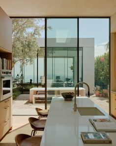 an open kitchen and living room with sliding glass doors