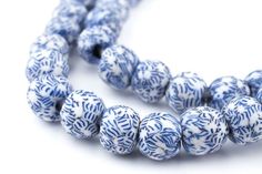 a blue and white beaded necklace on a white background