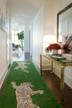 the hallway is decorated in white and green with leopards on it's rug