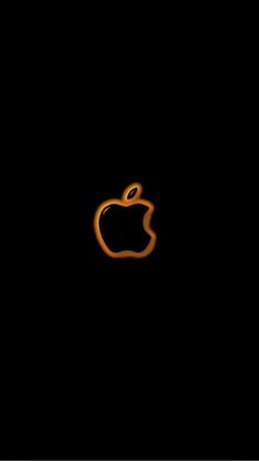 an apple logo in the dark with orange light coming from it's center side