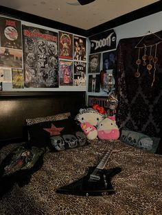 a bed room with a hello kitty stuffed animal on top of it and lots of posters