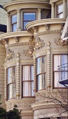 an ornately designed house with many windows and balconies