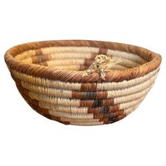 a brown and white basket sitting on top of a table