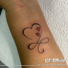 a small tattoo with two hearts on the left arm and an infinite knot in the middle