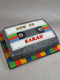 a cake made to look like an old school cassette tape recorder with the words how am i? on it