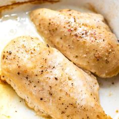 two pieces of chicken in a white dish