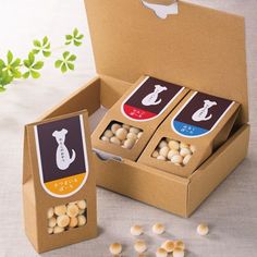 three boxes filled with white chocolates sitting on top of a table