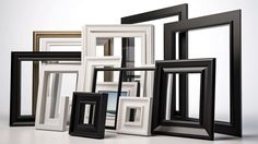 an assortment of black and white frames on a white surface with one empty frame in the middle