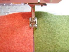 the sewing machine is working on the fabric that has been stitched together to make it more colorful