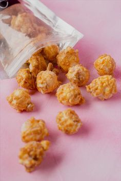 small pieces of food sitting on top of a pink surface next to a plastic bag