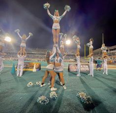 the cheerleaders are doing tricks on the field