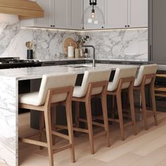 a kitchen with marble counter tops and stools