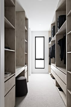 an empty walk in closet with shelves and drawers