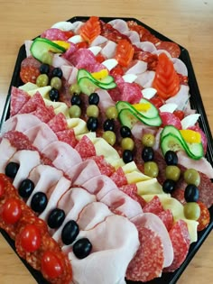 an assortment of meats and vegetables on a platter