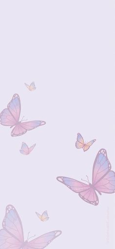 several pink butterflies flying in the sky with one on it's back and two on its side