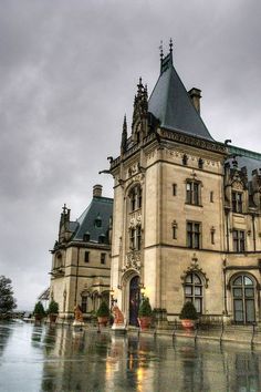 a large building with a clock tower on the top of it's roof and windows