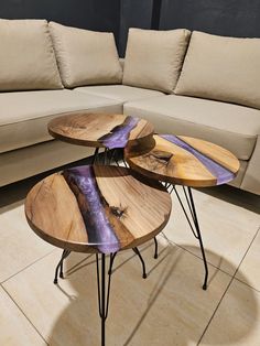 three wooden tables sitting on top of each other in front of a beige sectional couch