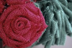 two knitted roses sitting on top of each other