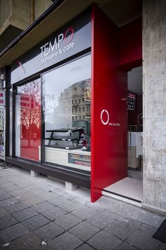 there is a red and black store front on the street